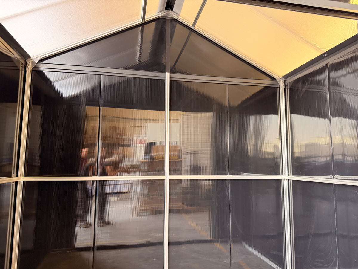 Inside the DOMER Smart Midnight Shed with black opaque walls, translucent roof and grey interior profiles