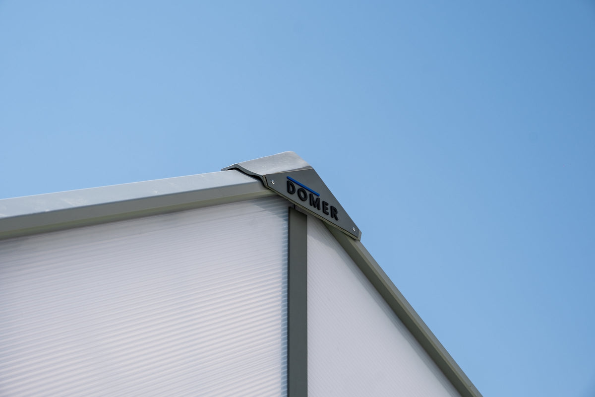 DOMER Smart Arctic Shed roof detail with DOMER badge and grey profiles #Profile colour_Grey