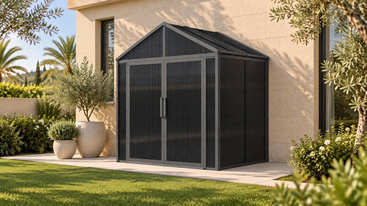 DOMER Smart Slate Shed with black profiles beside a villa courtyard #Profile colour_Black